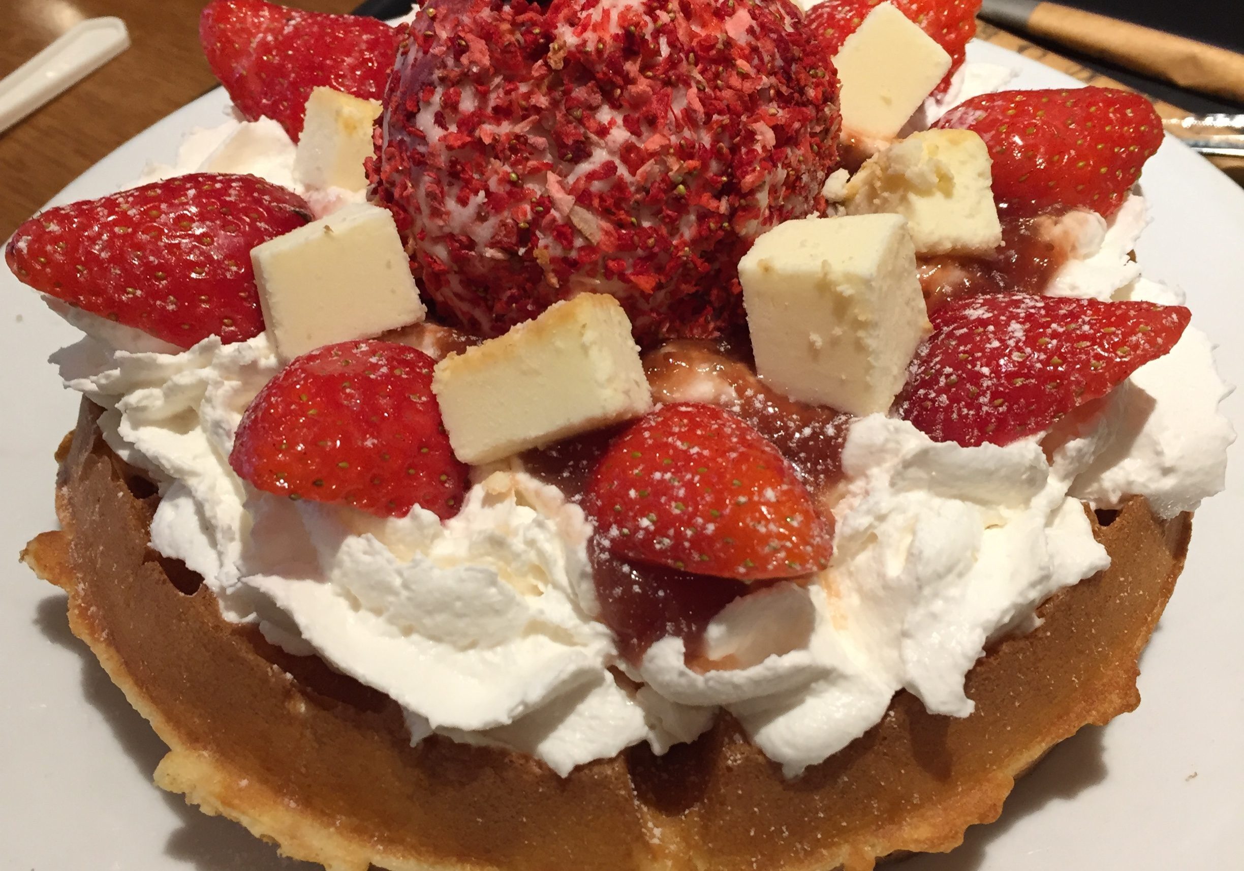 Fresh cream, strawberries, cheese cubes on fresh waffles! 